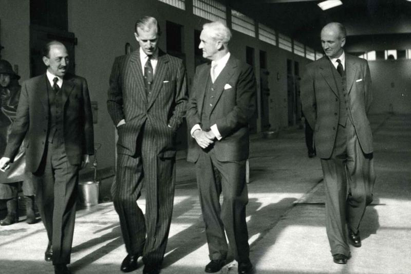 HRH Prince Philip, The Duke of Edinburgh, walks with 3 Pirbright staff on a 1956 visit