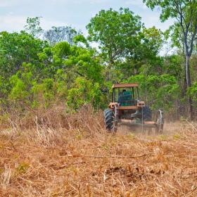 Agricultural tractor setting up pasture land stock photo